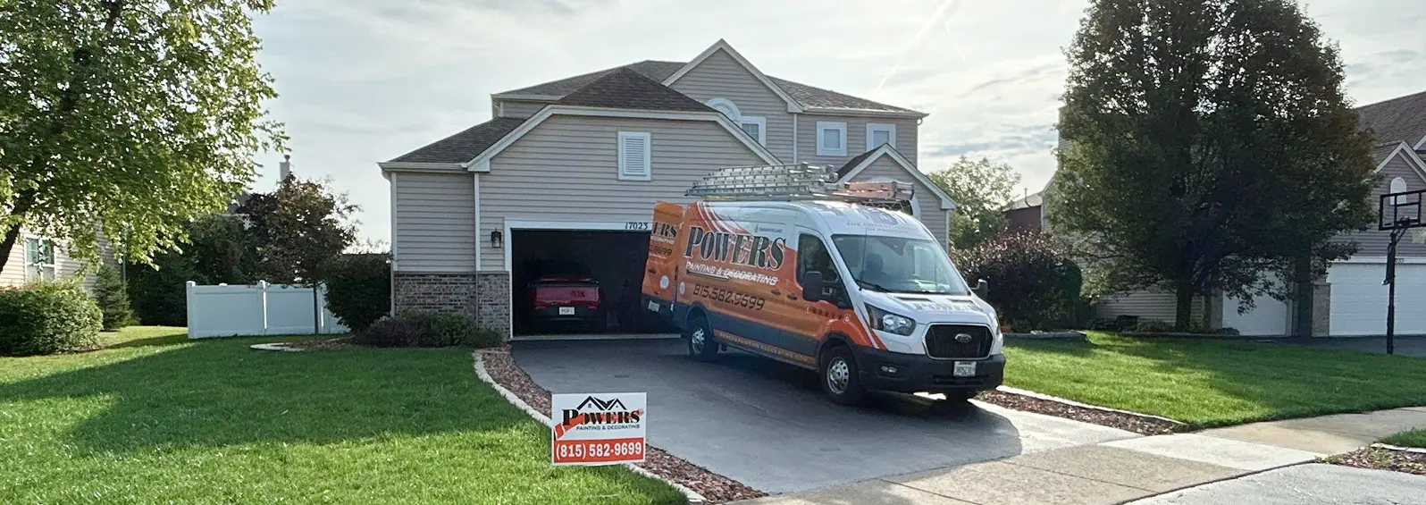 Powers Painting service van parked in front of a suburban home before exterior work