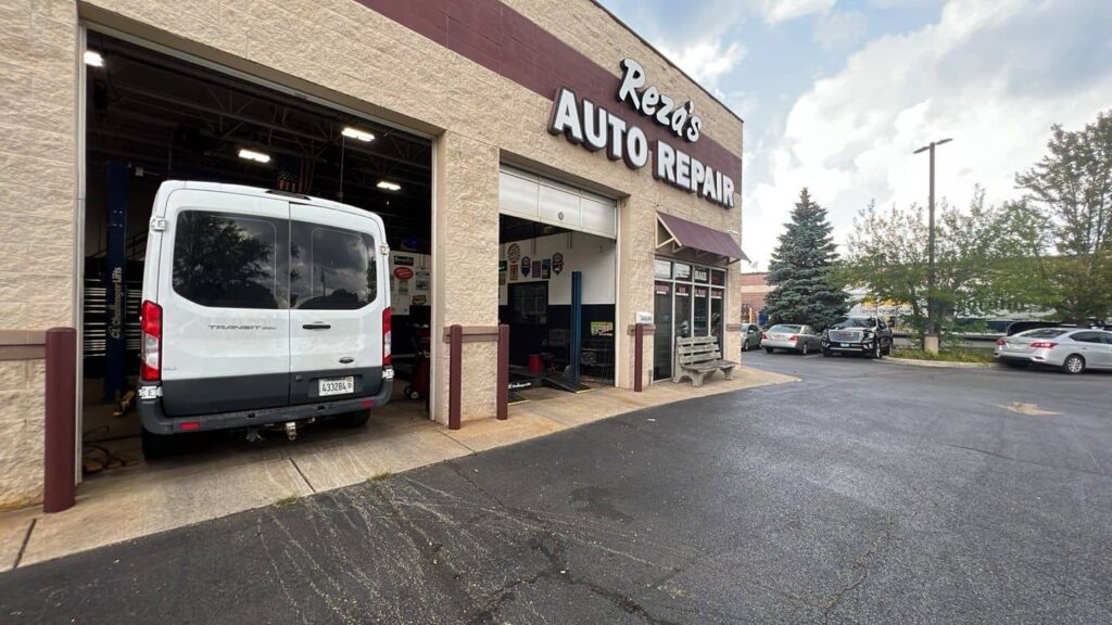 Auto repair shop exterior with a repainted maroon storefront and open service bay