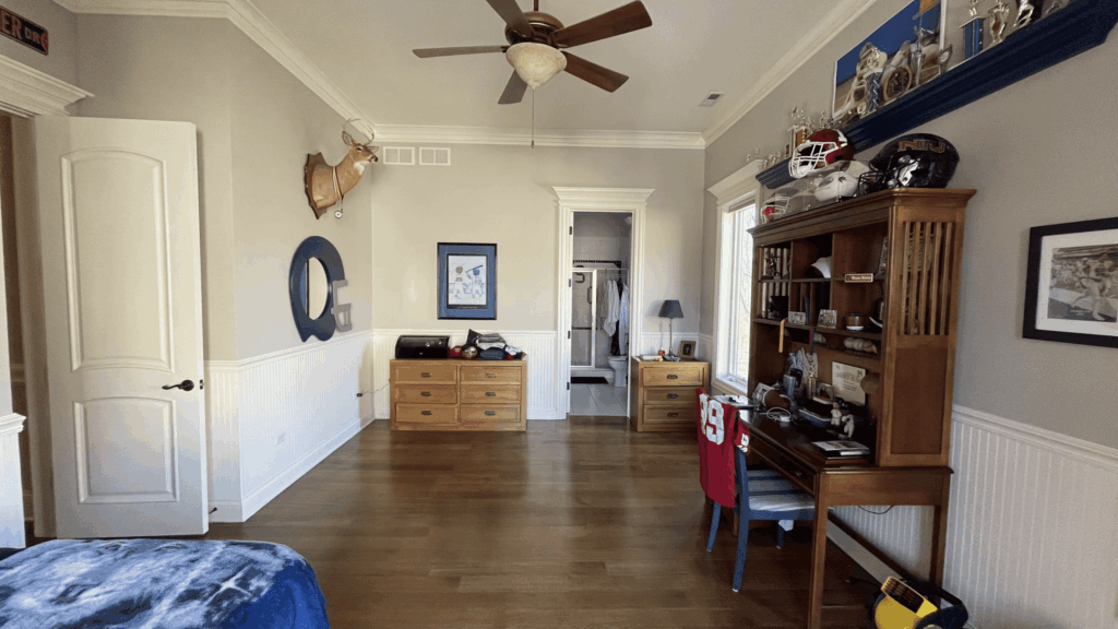 Room with gray walls, white wainscoting and dark hardwood flooring