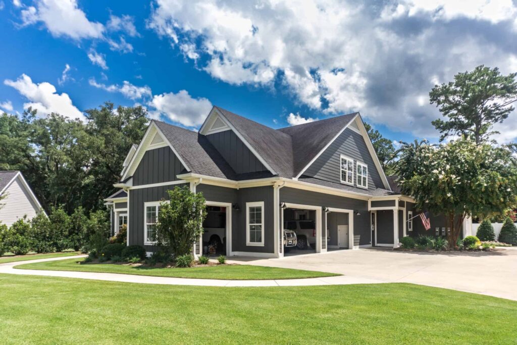 Large gray craftsman home with white trim showing durable exterior paint