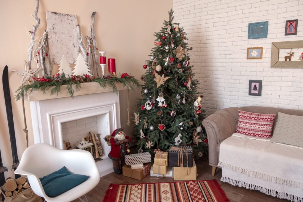 Living room with a white painted brick fireplace decorated for the holidays
