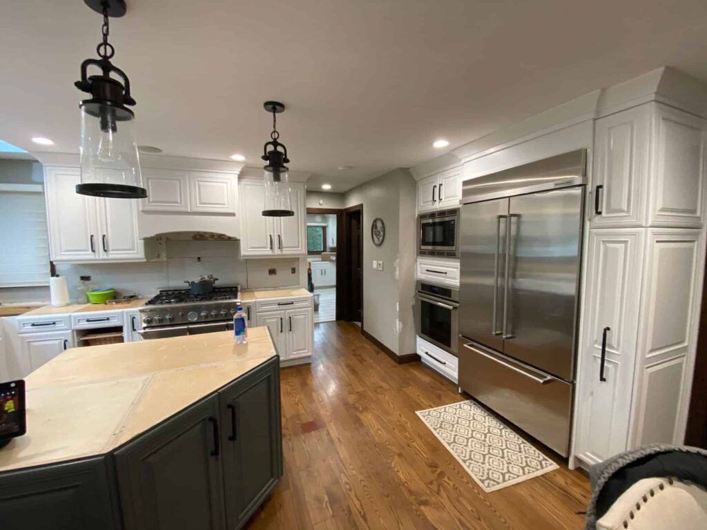 White painted kitchen cabinets and a wood top island in Minooka, Illinois