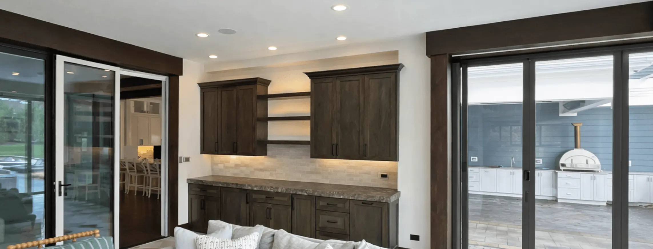 Living room with a dark stained wet bar and built-in shelving
