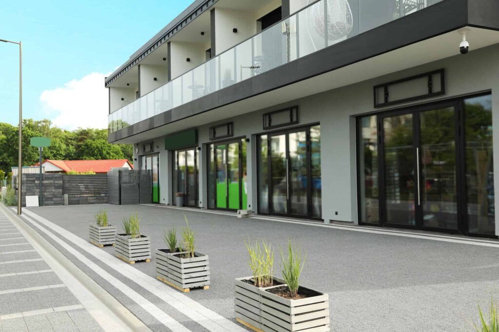 Modern commercial storefront with white painted walls and glass entrances