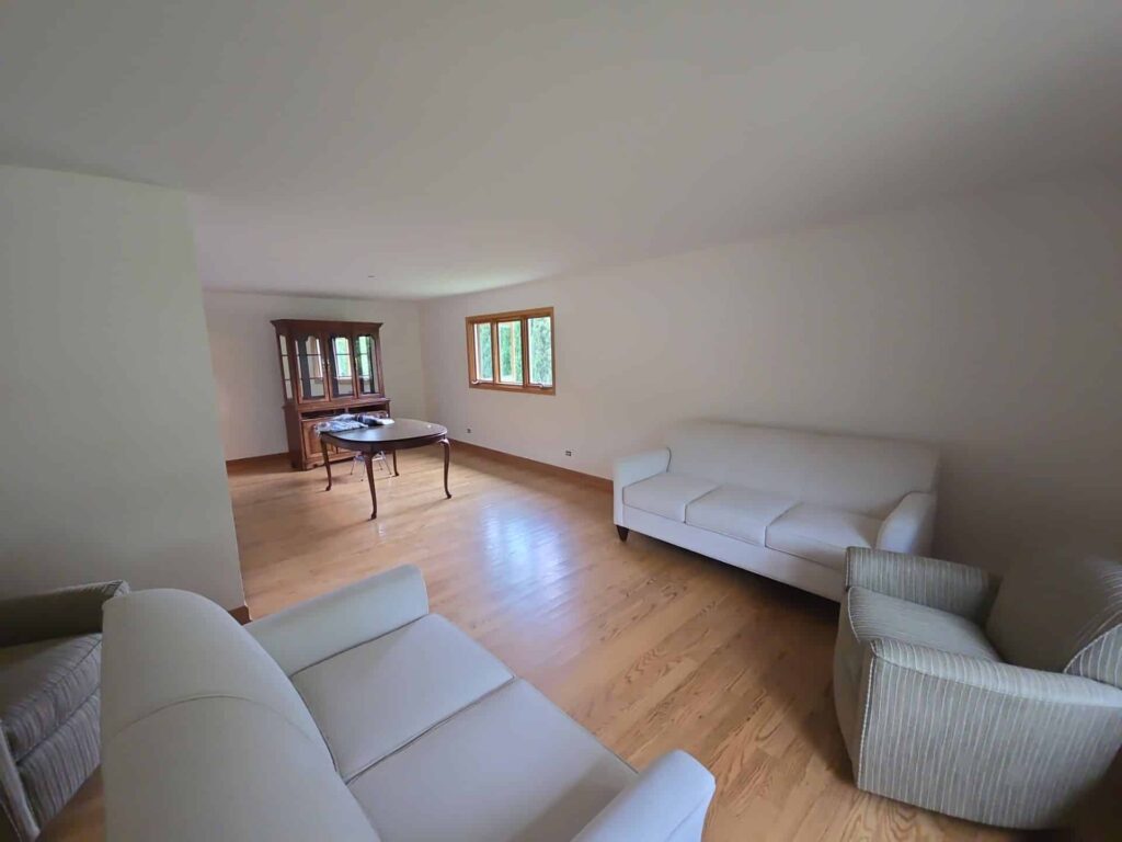 Neutral living room with freshly painted warm white walls and light wood flooring