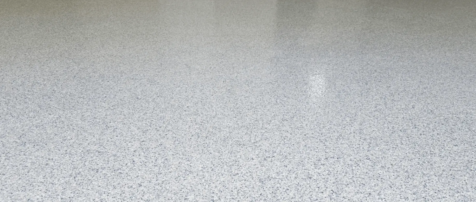 Close-up of an off-white speckled residential epoxy floor coating