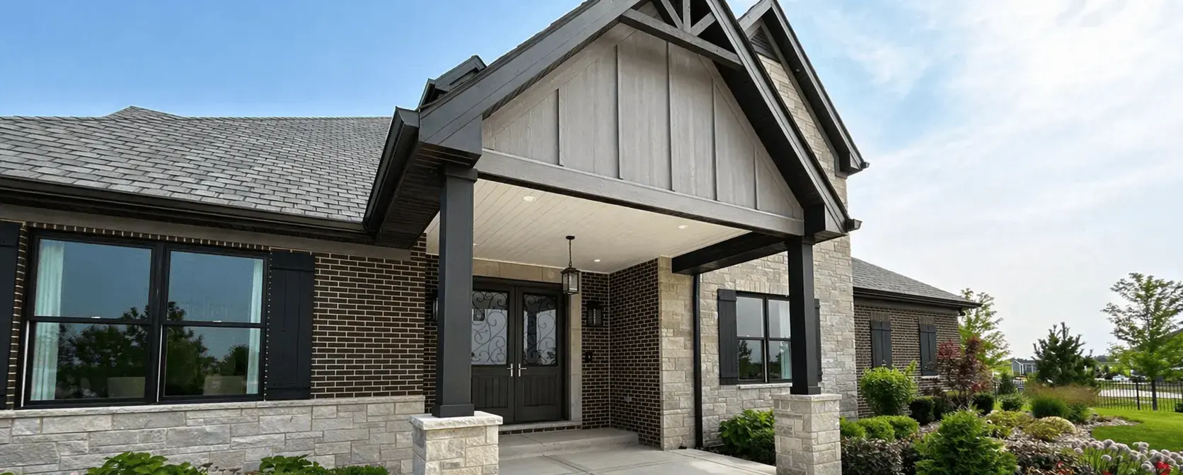 Modern gray home with board-and-batten siding and a covered porch painted in Minooka, Illinois