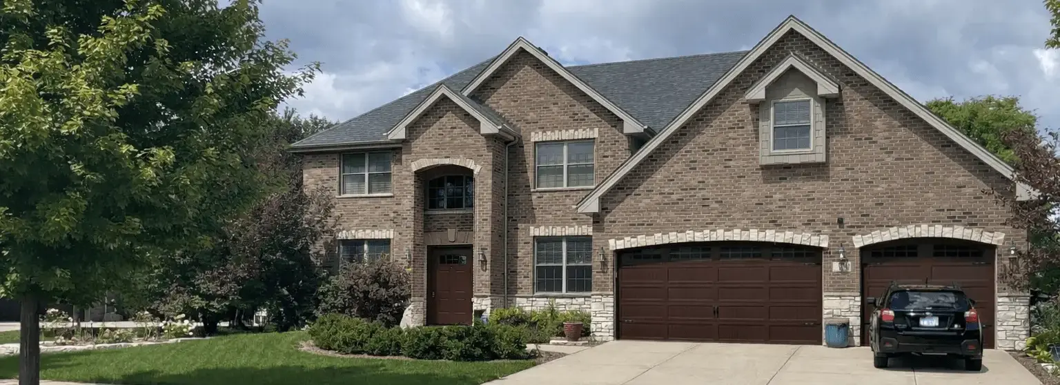 Two-story brick home with a freshly painted garage door and trim in Frankfort, Illinois